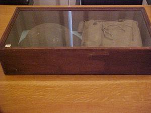 Shadowbox with doughboy helmet and bag