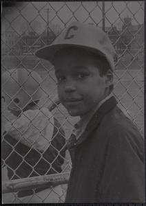 Boy standing next to baseball field