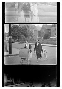 Maude Sanromá pushing a baby carriage while another woman holds a child's hand