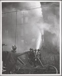 Boston fire fighters combatting building fire, East Boston