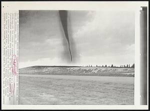 The Funnel Of Terror – Swirling onward is a tornado, a funnel-shaped ominously dark cloud, in the sky over Kansas. This is one of a spectacular sequence of pictures on the tornado taken about 25 miles west of Salina, Kan., by Henry Perez, a Kansas Highway Patrol trooper. This tornado, on a stormy night in May 1970, was in open country