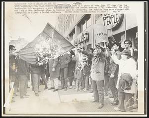 Demonstrators, part of a group of more than 200 Jews from the Washington, D.C. area, burn a mock Russian flag near the Soviet embassy 12/25 protesting the death and long prison sentences given to Russian Jews in Leningrad. The Russian Jews were charged with attempting to hijack a Soviet airliner.