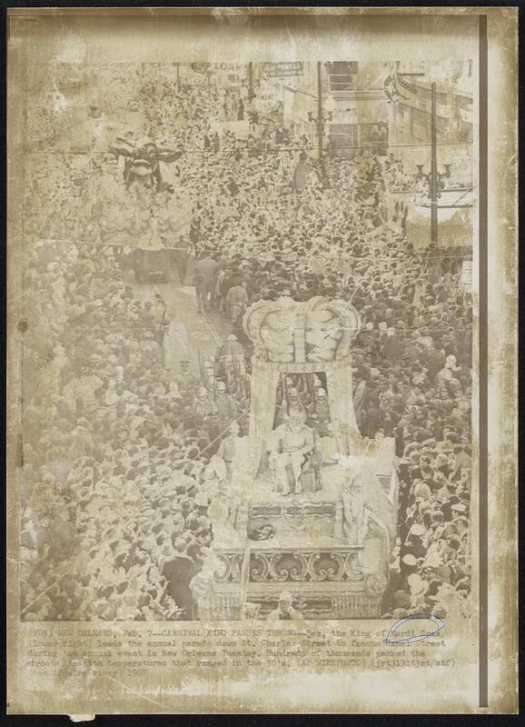 Carnival King Passes Throng-Rex, the King of Mardi Gras, (lower right) leads the annual parade down St. Charles Street to famous Canal Street during the annual event in New Orleans Tuesday. Hundreds of thousands packed the streets despite temperatures that ranged in the 30's.