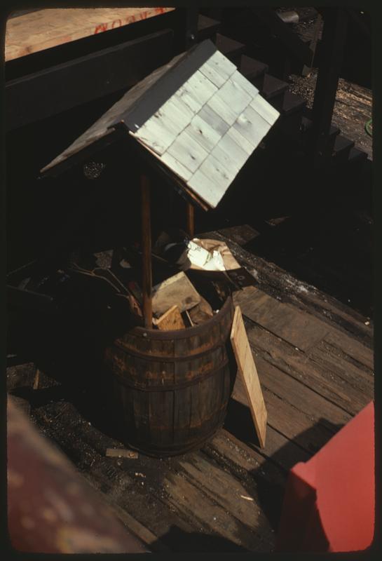 Barrel wishing well filled with trash