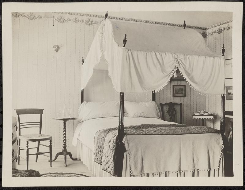 Bedroom with canopy bed, antiques, and wallpaper