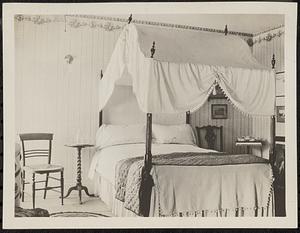 Bedroom with canopy bed, antiques, and wallpaper