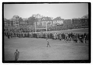 Crowd surrounding a football field