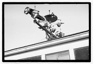 An elaborate device on roof, possibly a weather vane