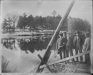 Dam in rear Mill #5 showing group of men and flashboards which were not removed all winter