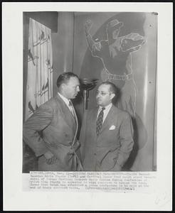 Discuss Cardinal Managership -- Giants Second - baseman Eddie Stanky (left) and Cardinal Owner Fred Saigh stand beneath mural of former Cardinal Manager Marty Marion during conference at which time Stanky in expected to sign contract to manage the team. Owner Fred Saigh has scheduled a press conference to be held at the end of their contract talks.