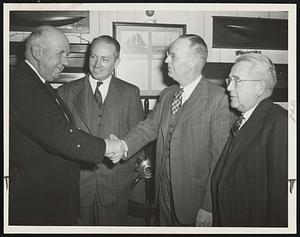 Corinthian Yacht Club Commodore Retires -- He's Richard D. Seamans (left) and he's shaking hands with Vice-Commodore T. Carlton Rowen. Secretary Fred M. Knight is between them. Treasurer Frank J. McManus is at right.