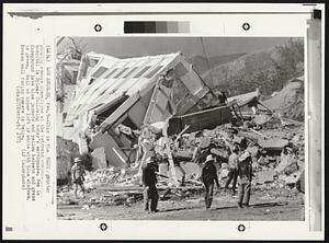 This is the Blue printer showing rescue operations at the Veterans Administration hospital in Sylmar following today's earthquake. Men in foreground have blue jackets and yellow helmets and grass is green. Wall at upper left is white with blue windows. Broken wall facing camera is beige.