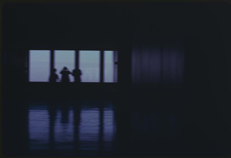 Three people by a window