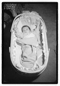 A baby in a bassinet