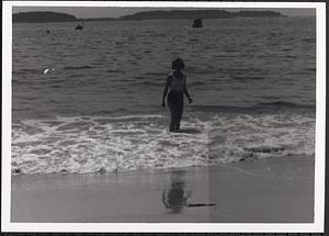Woman standing in the surf at the beach