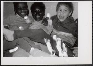 A woman with two boys smiling
