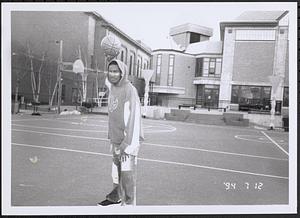 Young man standing on a basketball court