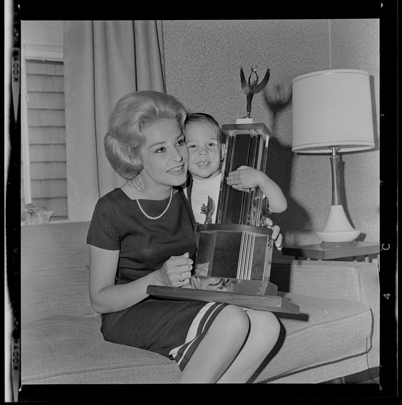 Elaine Nash, 22, selected Miss Massachusetts, holding trophy and her son, Robert, Jr., in their Freeport St., Dorchester home