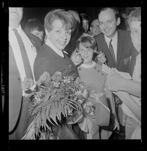 Judy Garland, in Hub for Boston Common concert, receives bouquet of roses from Cathy Sandler, daughter of Malcolm Sandler, N.E. Operations Manager for Knickerbocker Beer