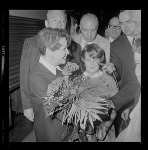 Judy Garland, in Hub for Boston Common concert, receives bouquet of roses from Cathy Sandler, daughter of Malcolm Sandler, N.E. Operations Manager for Knickerbocker Beer