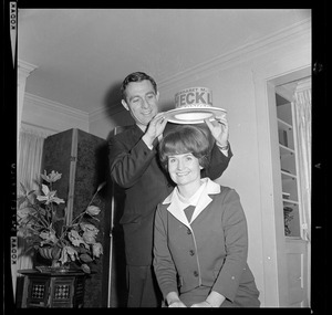 John Heckler placing a Margaret Heckler for Congress hat on Margaret Heckler's head