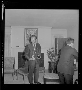 Two unidentified men in the home of Margaret Heckler