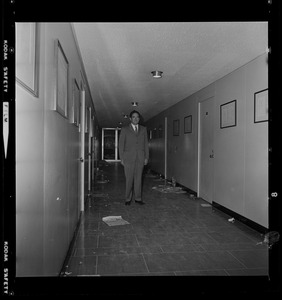 Brandeis University President Morris Abram in administration building hallway after sit-in