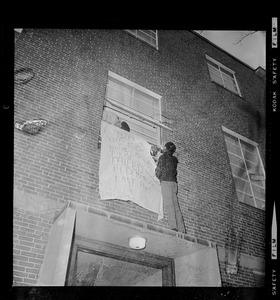 Students hanging banner during occupation of Ford Hall at Brandeis University