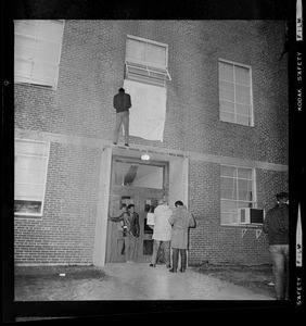 Students hanging banner during occupation of Ford Hall at Brandeis University