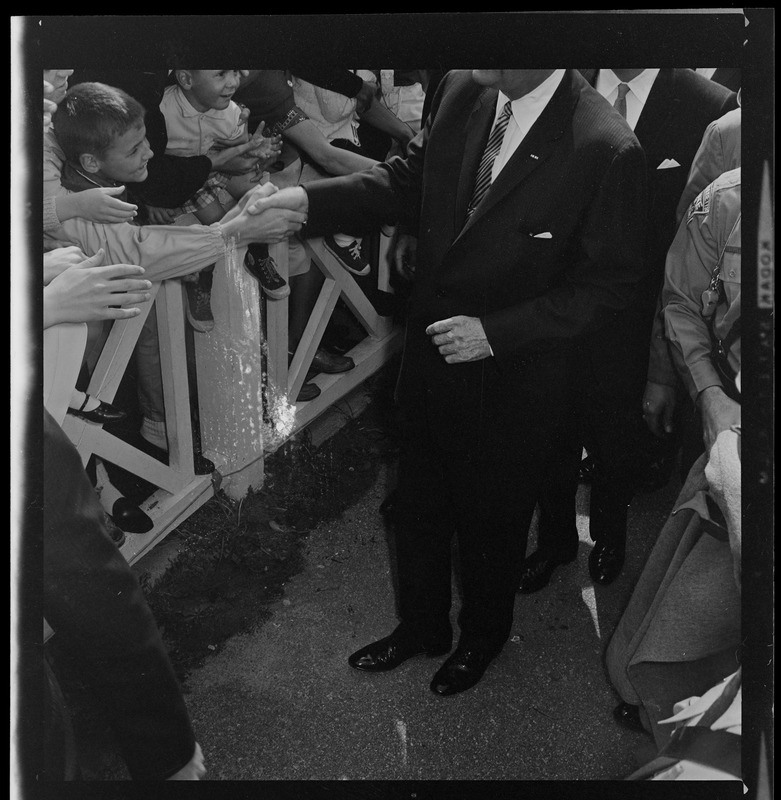 Lyndon B. Johnson greeted by crowds between Worcester Airport and Holy Cross Stadium