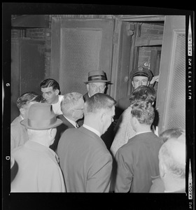 Boston School Superintendent William H. Ohrenberger and crowd of people entering back door of Boston School Committee headquarters