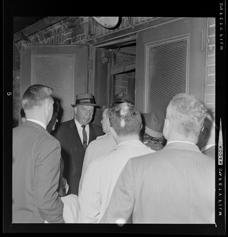 Boston School Superintendent William H. Ohrenberger and crowd of people entering back door of Boston School Committee headquarters