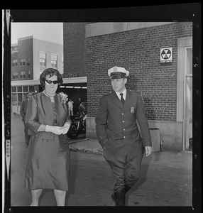 School Committee Chairman Louise Day Hicks guarded by Boston Police as she left City Hospital