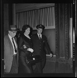 Louise Day Hicks leaving Boston School Committee meeting escorted by Sgt. John Hames and unidentified police officer