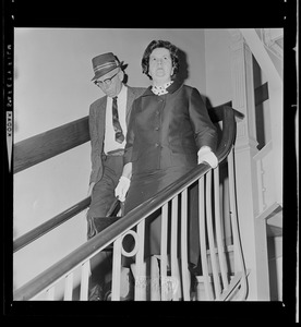 Louise Day Hicks leaving Boston School Committee meeting escorted by Sgt. John Hames