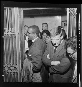 Rev. Virgil A. Wood entering crowded elevator in Boston School Committee headquarters