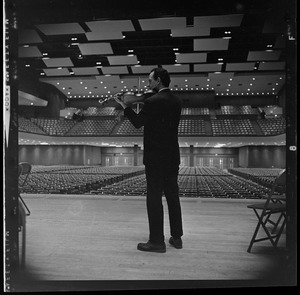 Violinist on stage in empty War Memorial Auditorium