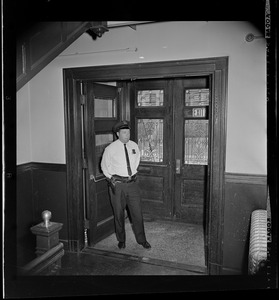 Police officer standing in entrance to a school