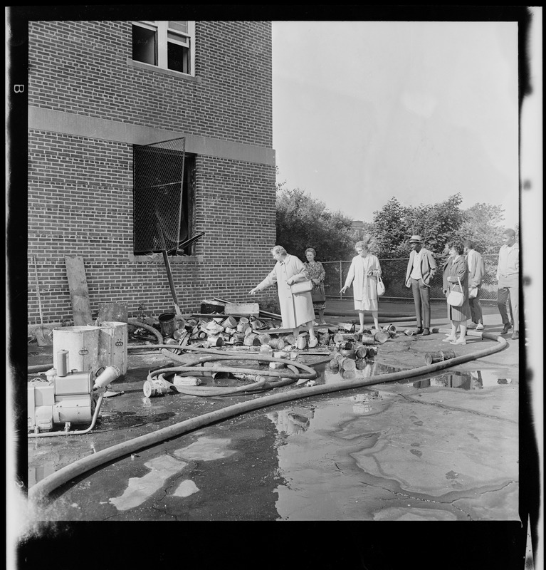 People examining fire damage at Timilty Junior High School