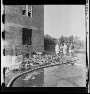 People examining fire damage at Timilty Junior High School