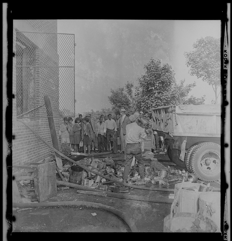 People examining fire damage in kitchen at Timilty Junior High School