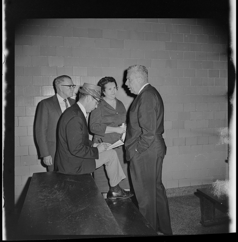 Principal John Dacey, an unidentified man, School Committee Chair Louise Day Hicks, and Superintendent William Ohrenberger at Timilty Junior High School day after fire at the school