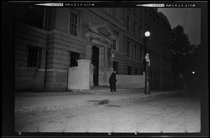 Police officer outside entrance to building