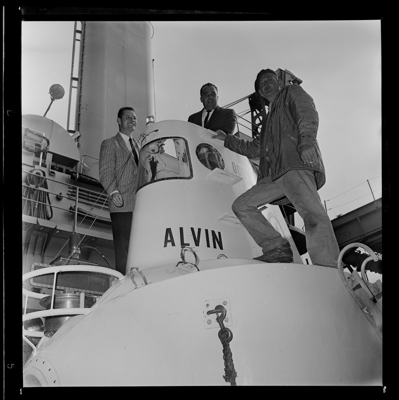 Marvin McCamis, Valentine Wilson, and George Roderson standing on research submersible Alvin at South Boston Navel Annex