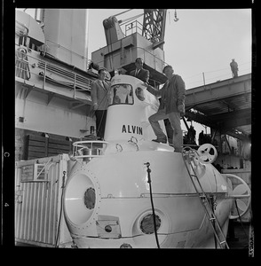 Marvin McCamis, Valentine Wilson, and George Roderson standing on research submersible Alvin at South Boston Navel Annex