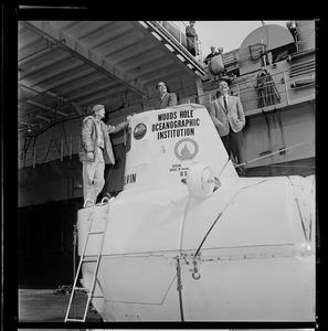 George Roderson, Valentine Wilson, and Marvin McCamis standing on research submersible Alvin at South Boston Navel Annex