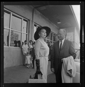 Zsa Zsa Gabor standing with unidentified man at Logan Airport