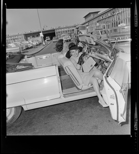 Zsa Zsa Gabor getting into passenger seat of convertible