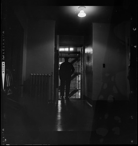 Prison guard standing in doorway