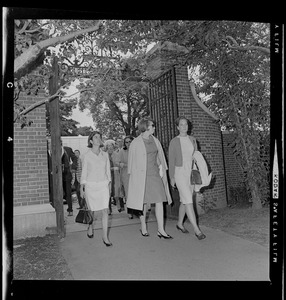 Princess Christina Bernadotte of Sweden walking through Radcliffe College gate with Mary Jan Ryder on right and others
